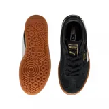 Championes Puma modelo Palermo Elevata, de diseño urbano con capellada de gamuza negra, franja lateral característica en blanco y suela de plataforma color caramelo.