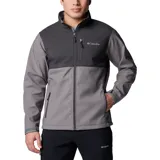 Chaqueta Columbia Ascender Soft Shell con diseño bicolor en tonos gris y gris oscuro. Cuenta con cierre frontal completo, cuello alto con protector de mentón, bolsillo en el pecho con cierre, bolsillos laterales con cierre y puños ajustables con velcro.