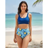 Bikini de dos piezas modelo Brenda, compuesto por un top tipo crop top liso en color azul y una bombacha de tiro alto con estampado floral y tropical en tonos celestes, azules y amarillos.