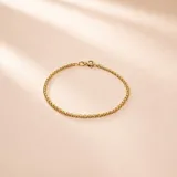 Pulsera Bismark en oro amarillo de 18k, de diseño fino y articulado con acabado brillante.