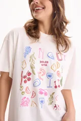 Remera oversize de algodón blanca con estampado multicolor de motivos veraniegos y la frase "Dolce Vita" en el centro.