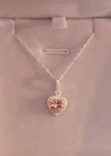 Collar de plata 925 con cadena eslabonada estilo Singapur y dije en forma de corazón con piedra zirconia rosa central rodeada de un pavé de zirconias pequeñas.