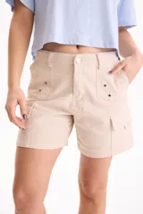 Short cargo negro de gabardina, de tiro medio con bolsillos laterales tipo parche y detalles de ojalillos metálicos en los bolsillos delanteros.