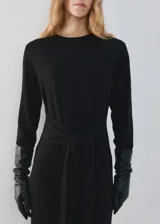 Vestido midi negro de manga larga, con escote redondo, lazo ajustable en la cintura y tajo lateral.