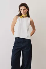 Musculosa blanca de corte recto y escote redondo, confeccionada en tejido de algodón.
