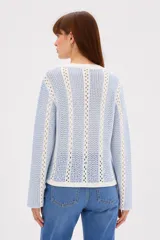 Sweater de algodón de punto con diseño a rayas verticales en color rojo y blanco, cuello redondo y mangas largas.