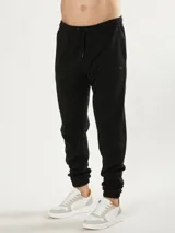 Pantalón de jogging negro, corte babucha, con cintura elastizada y cordón de ajuste. Confeccionado en tejido de algodón y poliéster.
