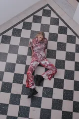 Pantalón palazzo de crepe de seda estampado con motivos florales en tonos fucsia, rojo y blanco. Tiene cierre invisible lateral y costura francesa.