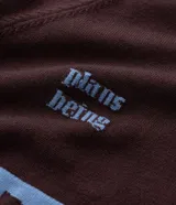 Suéter de punto en jacquard color bordó con diseño de cuello polo y cierre frontal parcial. Presenta estampado frontal con la palabra 'EASY' y la frase 'plans being' en color celeste, además de un pequeño logo bordado. Posee mangas largas con puños acanalados y un corte holgado.