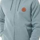 Canguro celeste con cierre frontal, capucha con cordones ajustables, bolsillos laterales y logo de Rip Curl en el pecho.