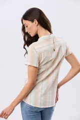 Camisa de lino de manga corta con cuello mao y cierre frontal parcial con botones. Presenta un diseño de rayas verticales en tonos suaves como rosa, verde, celeste y beige.