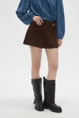 Short de tiro alto confeccionado en pana color marrón, con diseño de botones decorativos en la cintura y corte recto.