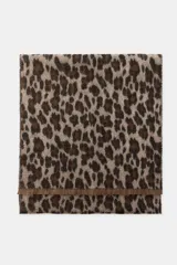 Pañuelo rectangular de tejido jacquard con estampado animal print en tonos marrones y beige, con terminaciones deshilachadas en los extremos.