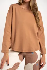 Sweater color marrón claro con textura tipo waffle, corte holgado y mangas largas.