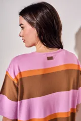 Vestido midi de tejido de punto con diseño de rayas horizontales en tonos rosa, naranja y marrón. Presenta cuello redondo, mangas cortas y un corte holgado con aberturas laterales en el ruedo.