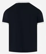 Remera blanca de algodón, modelo baby tee, con mangas cortas, cuello redondo y detalles contrastantes en marrón. Presenta un pequeño logo gomoso con la palabra "Lucky" en el centro del pecho.