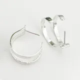 Par de caravanas tipo aro de plata 950 texturizada.