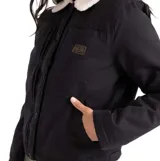 Campera estilo trucker color negro, con cuello de corderito blanco y cierre frontal con botones. Presenta un diseño de corte recto con bolsillos frontales y forro interior de polar.