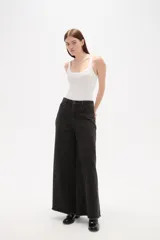 Pantalon de jean azul de corte ancho y tiro alto, con ruedo deshilachado.