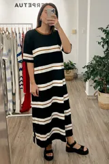 Vestido largo de tejido de punto a rayas horizontales negras, blancas y marrones.