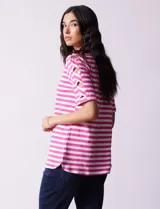Remera de algodón a rayas horizontales blancas y negras, con cuello redondo y mangas cortas con aberturas entrelazadas.