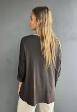 Blusa marrón de diseño holgado, con escote redondo y mangas largas. Confeccionada en la parte delantera con viscosa y algodón, y en la trasera y mangas con una mezcla de algodón, viscosa y lycra.