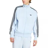 Campera deportiva Adidas Firebird color celeste con cierre frontal, cuello alto y bolsillos laterales con cierre. Presenta las icónicas tres tiras negras en los hombros y mangas, y el logo del trifolio bordado en el pecho.