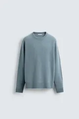 Jersey de corte regular fit confeccionado en una mezcla de lana y cashmere. Presenta cuello redondo, manga larga y acabados en rib en puños y bajo.