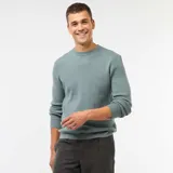 Sweater de punto con textura gofrada, cuello redondo y mangas largas con puños acanalados.