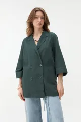 Blazer negro de corte recto y holgado, con doble botonadura frontal, solapas clásicas y mangas tres cuartos con costuras pespunteadas en contraste.