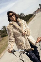 Campera oversize de largo medio en piel sintética, de diseño relajado con bolsillos funcionales y detalles bordados en la espalda.