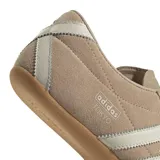 Championes Adidas Tokyo de mujer, confeccionados en gamuza suave de color beige con las icónicas tres tiras y detalles en blanco, y suela de caucho.