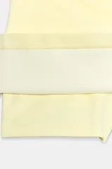 Falda pantalón de tiro bajo color blanco crudo, con diseño de cintura asimétrica y cierre lateral con cremallera oculta en costura.