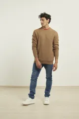 Sweater de punto fino azul con cuello redondo y terminaciones elásticas en canalé.