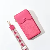 Porta celular fucsia con diseño floral en relieve, cierre de cremallera y correa de tela estampada con motivos geométricos.