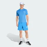 Remera deportiva Adidas de entrenamiento, color azul, con cuello redondo y mangas cortas. Presenta las icónicas tres rayas blancas en los laterales y el logo de la marca en el pecho. Confeccionada en tejido técnico transpirable con tecnología Climacool.