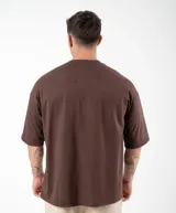 Remera negra de algodón, corte oversize, con inscripción 'GAINS.' en el frente.