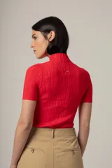 Camiseta de punto acanalado color marrón, con cuello alto y mangas cortas ajustadas.