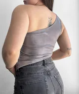 Top plateado de un solo hombro, con textura acanalada y corte ajustado.