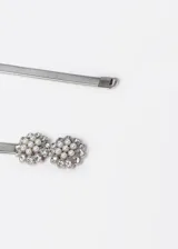 Cinto plateado elastizado con apliques de perlas y strass en forma de flor.