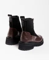 Botas cortas de cuero vacuno con textura de reptil, diseño con cierre frontal y suela de plataforma dentada de caucho.