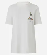 Remera de algodón color crudo con cuello redondo y mangas cortas. Estampa frontal pequeña y estampa trasera grande de Tom y Jerry.