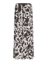 Pollera larga de corte recto confeccionada en tejido mesh con estampado animal print tipo vaca en tonos blanco y marrón oscuro. Presenta cintura elastizada y diseño fluido.