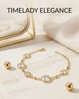 Pulsera de acero con baño dorado, compuesta por una cadena fina con dijes circulares engastados de circonias transparentes facetadas.