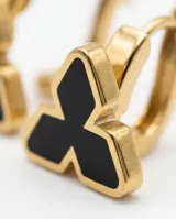 Aros tipo argolla pequeña con dije en forma de trébol o flor estilizada, con borde dorado y centro esmaltado en color negro.