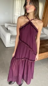 Vestido largo color bordó con escote halter y detalles de volados diagonales.