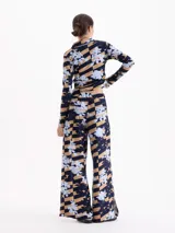 Pantalon de corte recto y tiro medio con diseño de estampado floral sobre un fondo de rayas horizontales en tonos azul marino y beige.