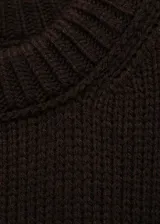 Jersey de punto grueso en color negro, con cuello redondo, diseño recto y mangas largas con puños elásticos. Presenta terminaciones en canalé en cuello, puños y ruedo.