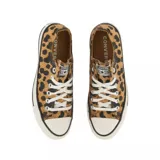 Championes Converse Chuck Taylor Ox de lona con estampado animal print tipo leopardo en tonos tostado y negro, con puntera de goma blanca y cordones blancos.