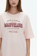 Remera de algodón negra con cuello redondo y mangas cortas, de corte holgado. Presenta estampado frontal en tonos de verde con la inscripción 'New York City Brooklyn' y el logo 'NY' rodeado de laureles.